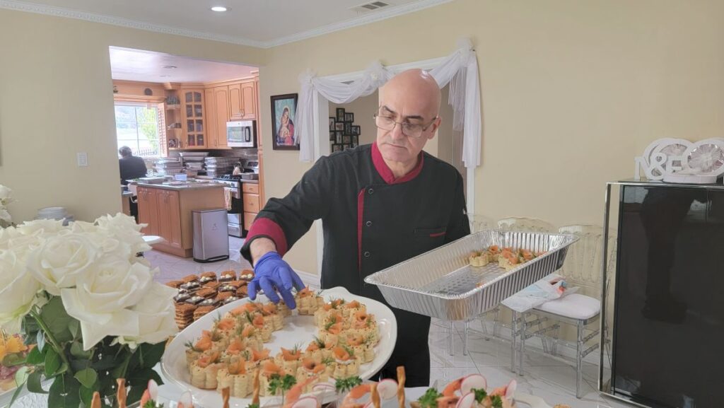 Premium event catering services featuring a gourmet Mediterranean and Italian appetizer table spread.