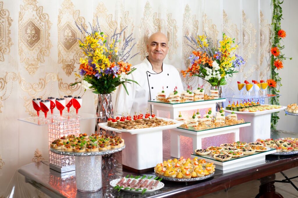 Full-service corporate catering services displaying a customized appetizer and dessert buffet layout.